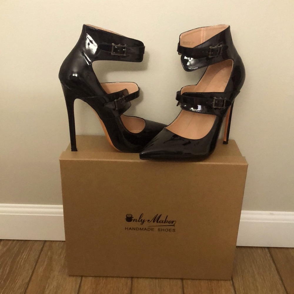 Black patent leather high heel shoes with buckles